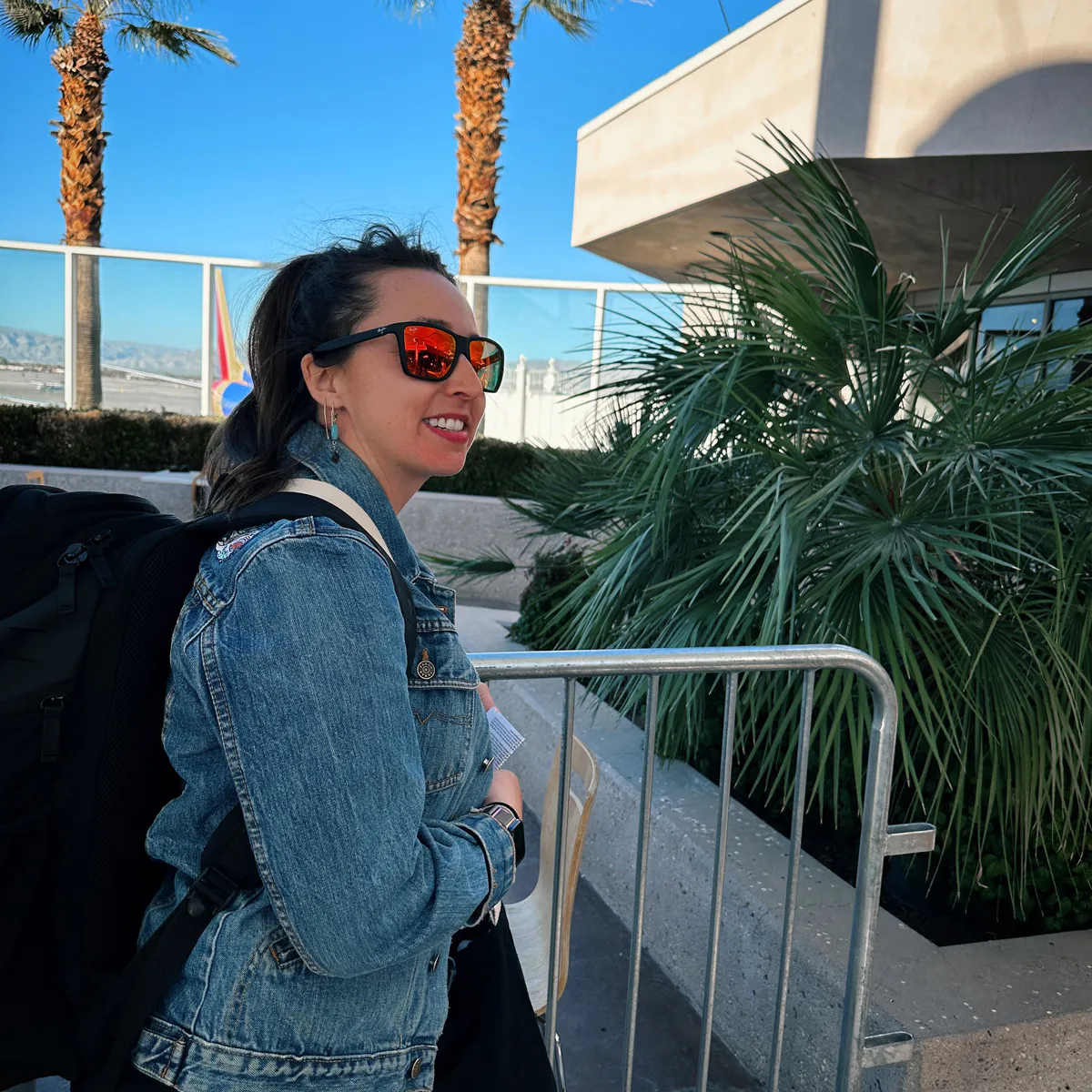 Traveler in sunglasses with a backpack outside Palm Springs airport