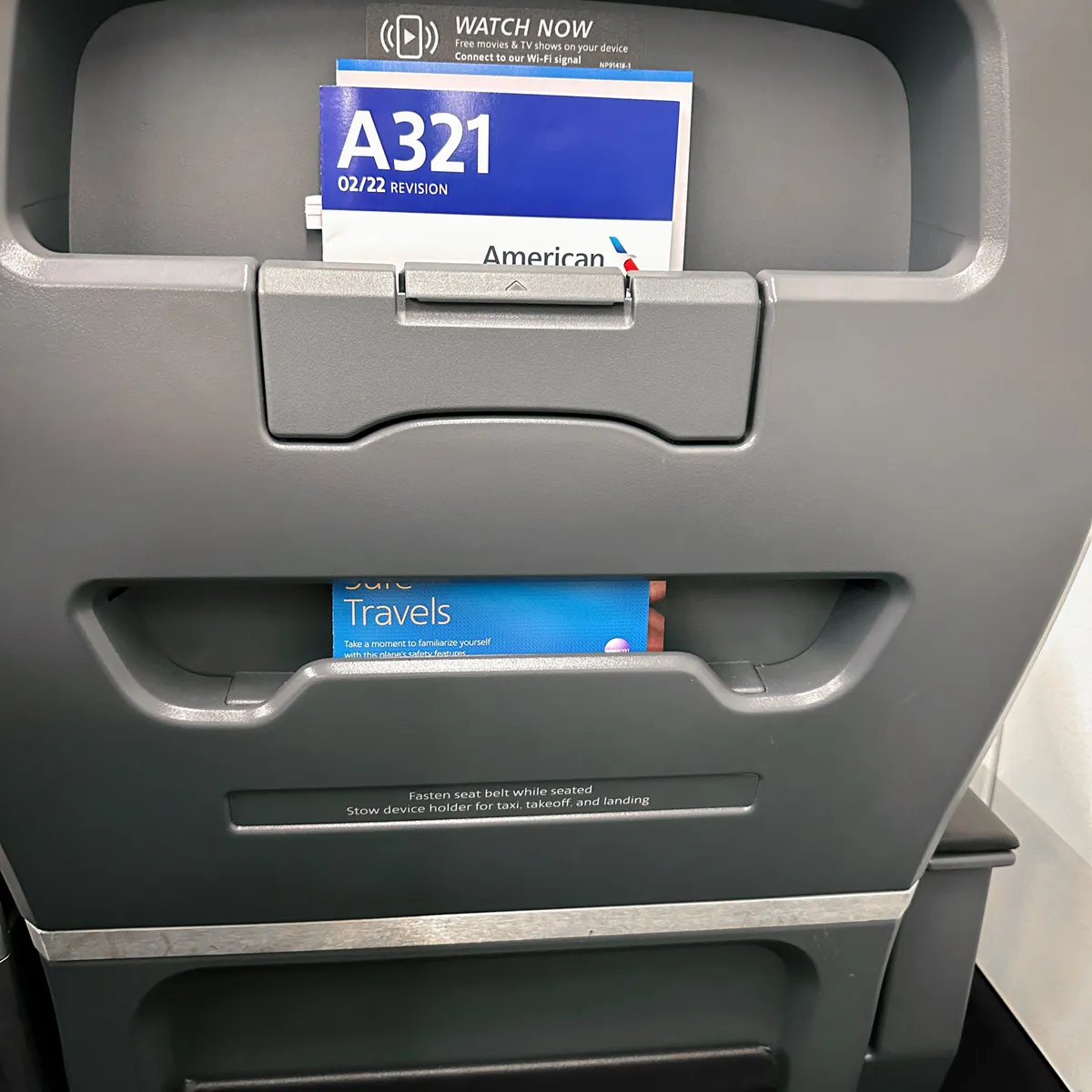 Gray airplane seatback pocket with an American Airlines A321 card