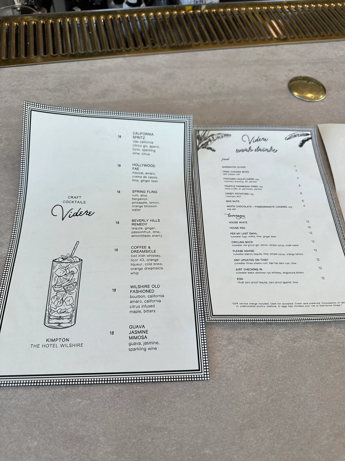 Two Videre menus listing cocktails, snacks, and drinks on the bar