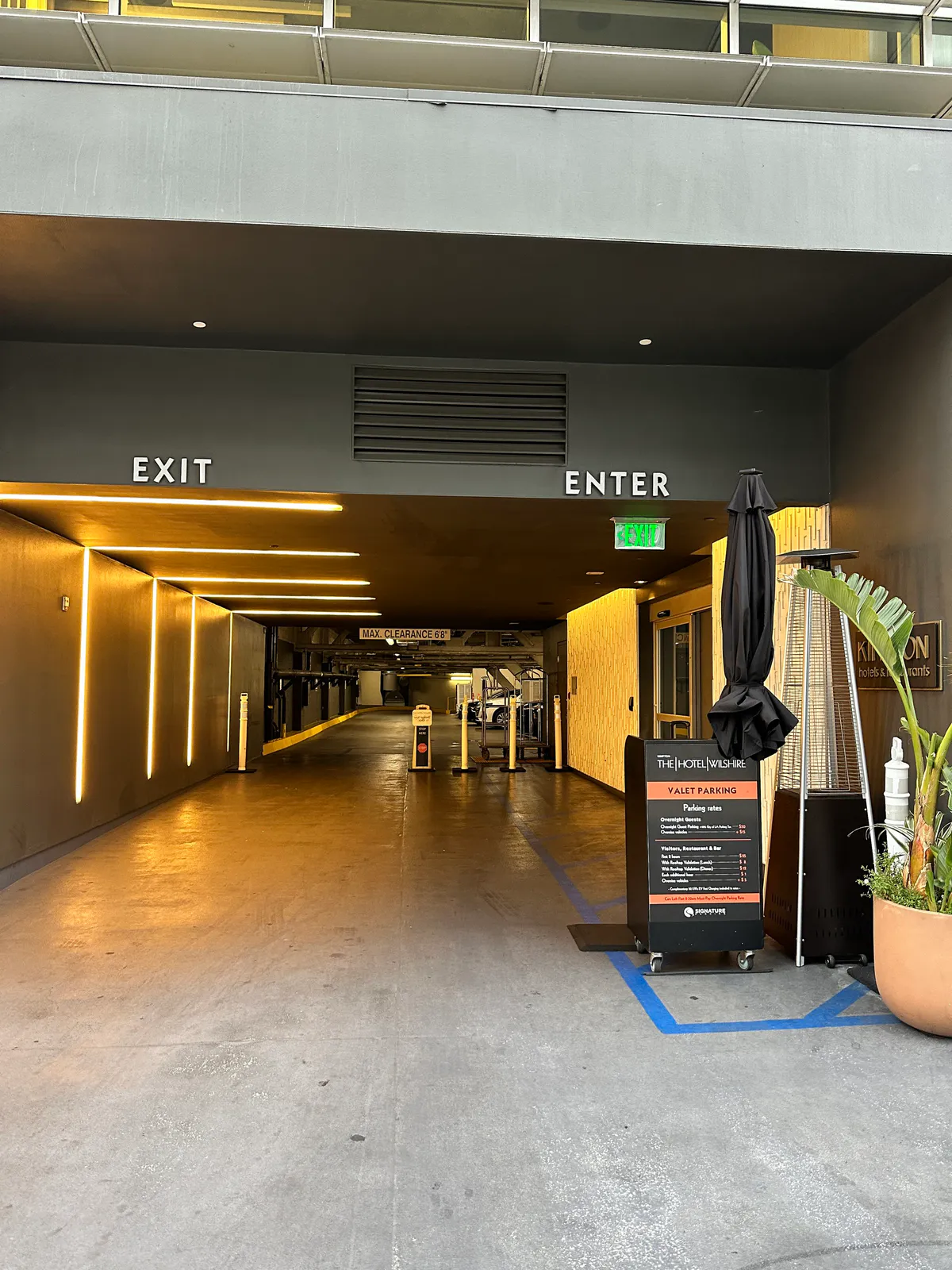 Covered driveway into the hotel garage with exit and enter signs