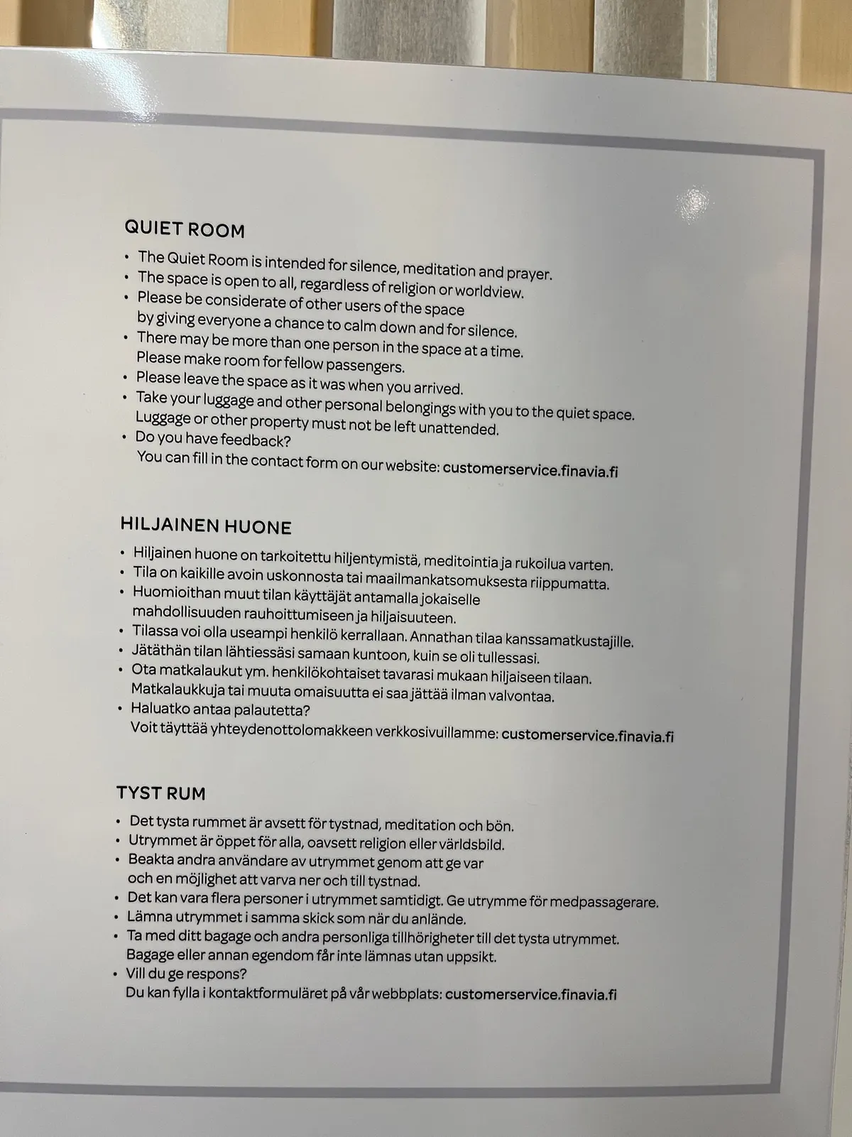 A Quiet Room notice posted in English, Finnish, and Swedish