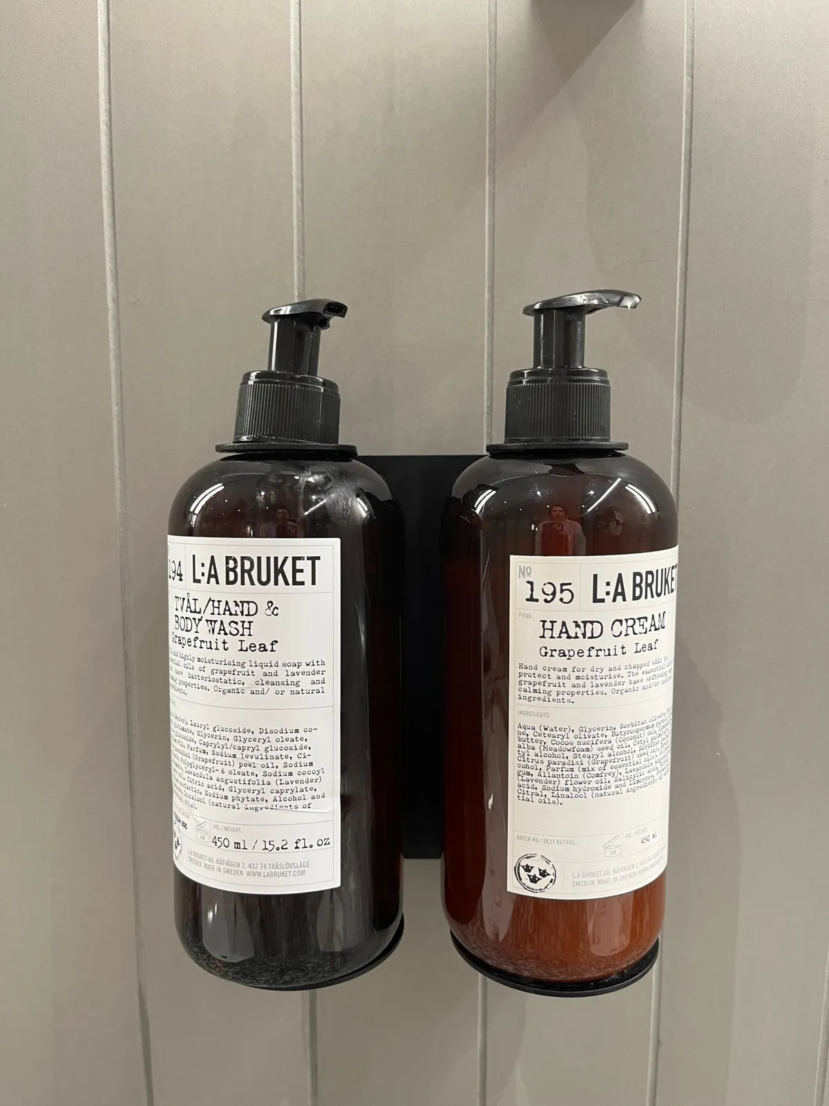 Wall-mounted pump bottles of L:A Bruket hand wash and hand cream