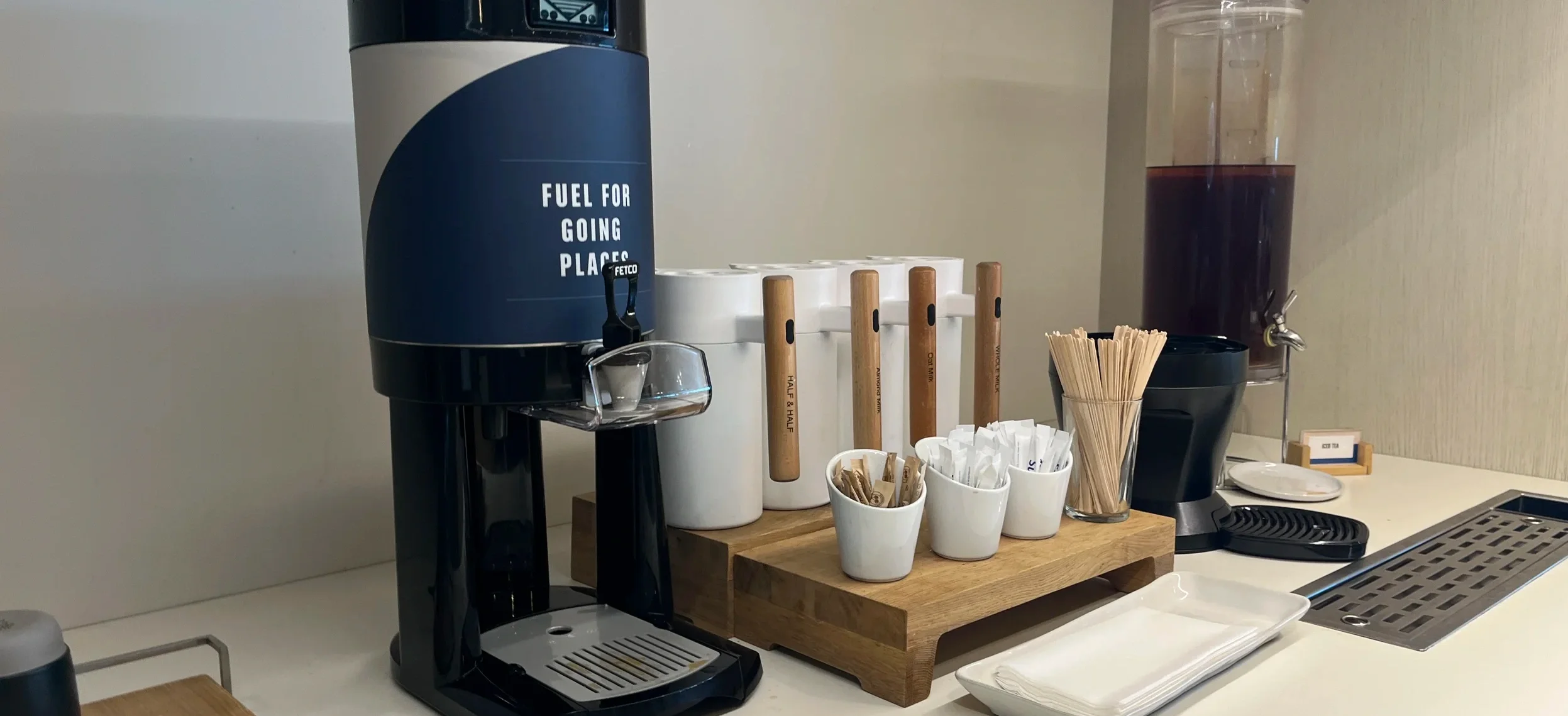 Coffee brewer labeled Fuel for Going Places, with mugs and a dispenser