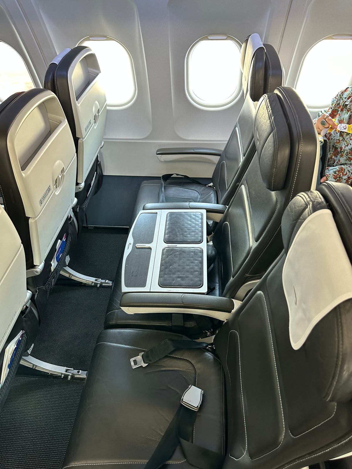 Club Europe seats by the windows, with a tray table in the middle seat